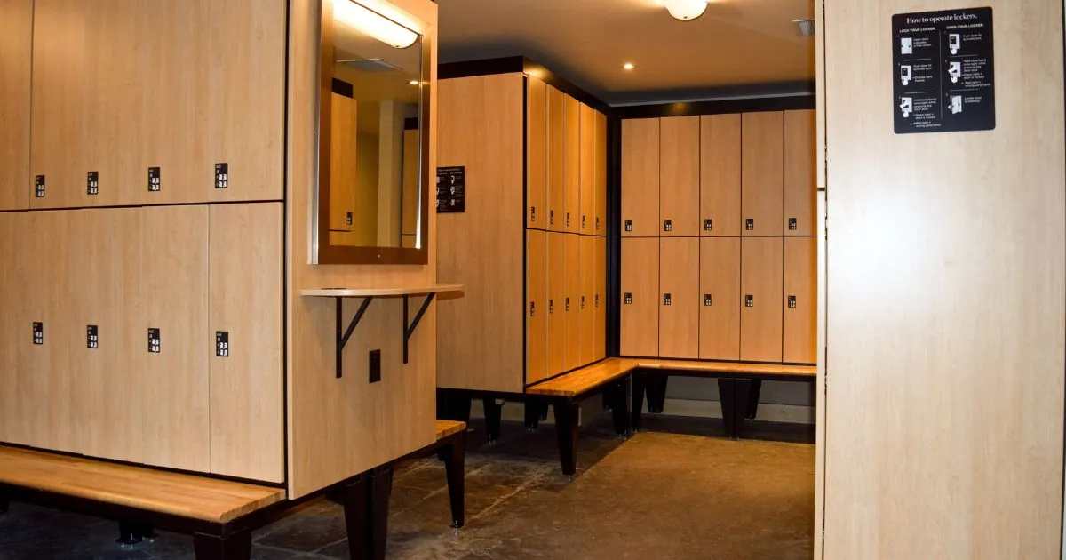 Spa locker room with wooden benches and Spacesaver day use lockers.