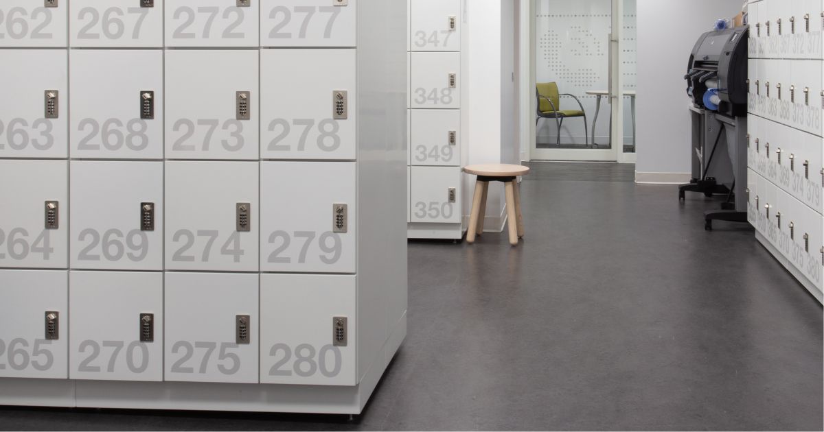 Light grey metal Spacesaver day lockers featuring large custom numbers and built in combination locks.